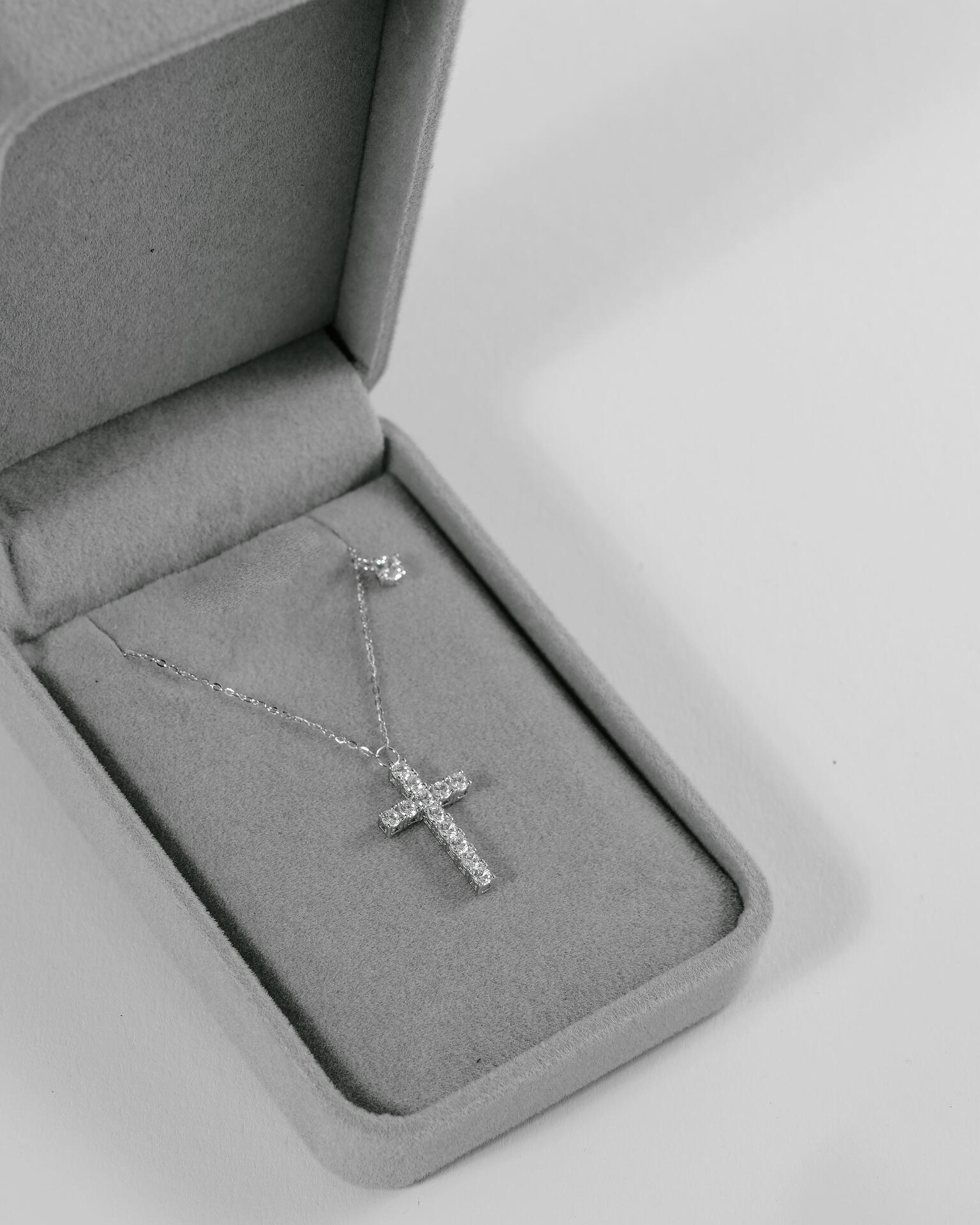 Silver necklace with a cross pendant with stones